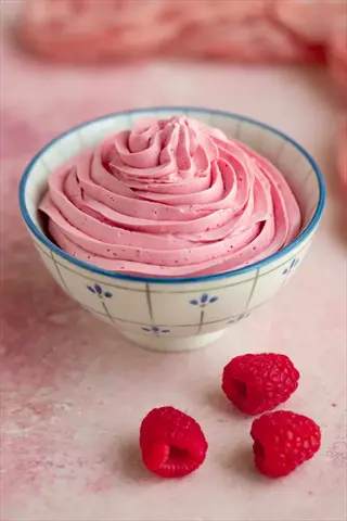 raspberry ice dessert in a decorative bowl with fresh raspberries