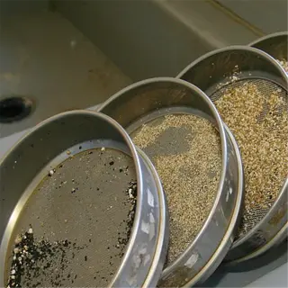 stack of stainless steel soil sieves with various particle sizes