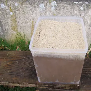 stratification containers: plastic tub with sandy top layer on wooden plank outdoors
