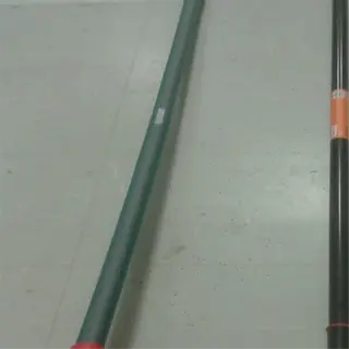 two gardening tools, including a garden hoe with a red handle, on a tiled floor