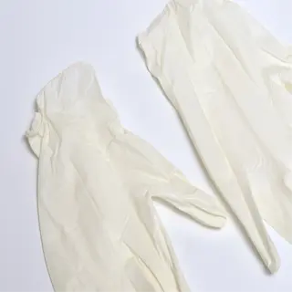 two latex gloves laid flat on a white surface
