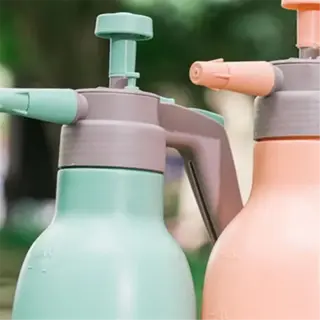 two pastel-colored pressure sprayers, one mint green and one peach
