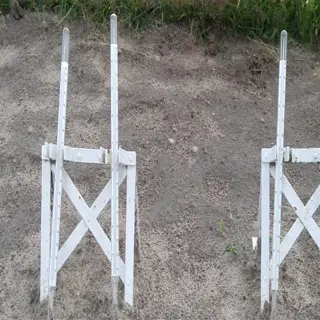 two white soil thermometers placed in the ground