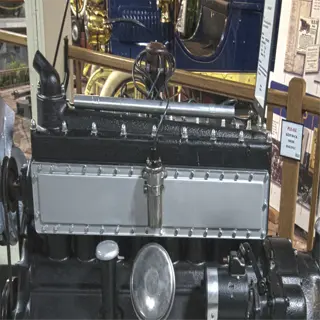 vintage straight eight engine on display in a museum setting