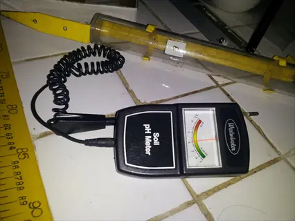 westminster soil ph tester (analog meter) on tiled surface with measurement ruler and labeled test tube in background