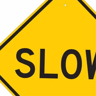 yellow diamond-shaped traffic sign with the word 'slow'