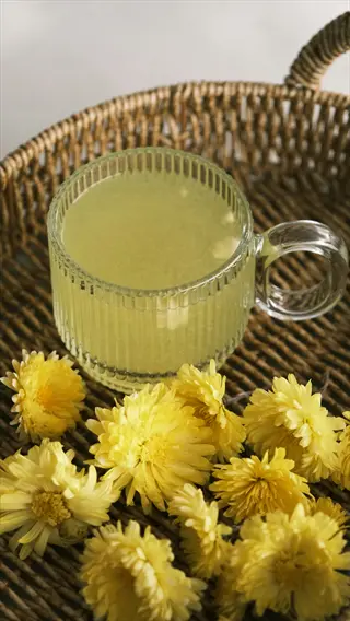 yellow tea glass cup on woven tray with yellow flowers